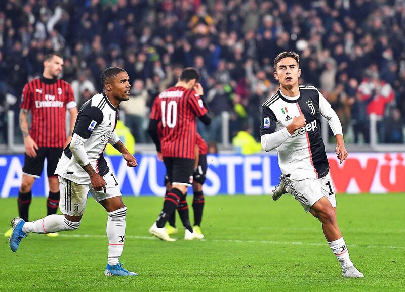 epa07987024 Juventus' Paulo Dybala (R) celebrates after scoring the 1-0 lead during the Italian Serie A soccer match between Juventus FC and AC Milan in Turin, Italy, 10 November 2019.  EPA/ALESSANDRO DI MARCO