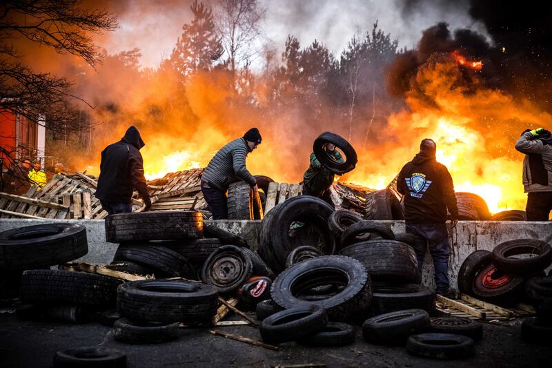 Dutch and Belgian farmers burn tyres and wood as they block the border crossing into Belgium at Arendonk in The Netherlands during protests over taxes, rising costs and bureaucracy. EPA