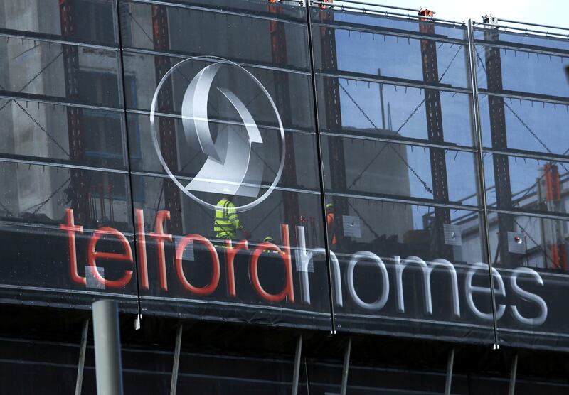 An advertising hoarding surrounds a Telford Homes Plc residential apartment block under construction in the Stratford district of London, U.K., on Wednesday, July 6, 2016. Photographer: Chris Ratcliffe/Bloomberg