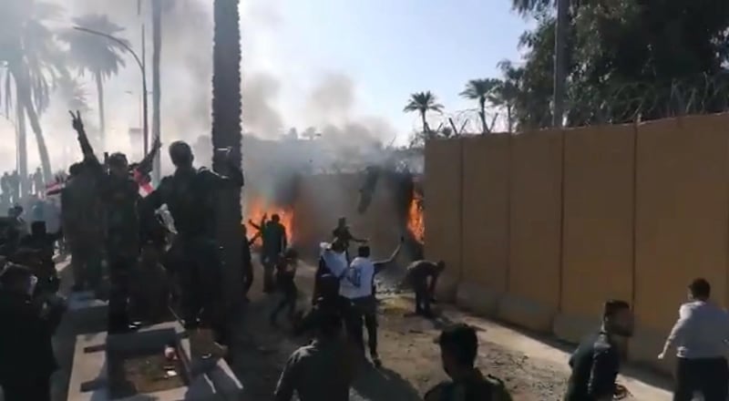 Kataib Hezbollah militia supporters burning the outer fence of the US embassy.  @SaadoonMustafa via Twitter