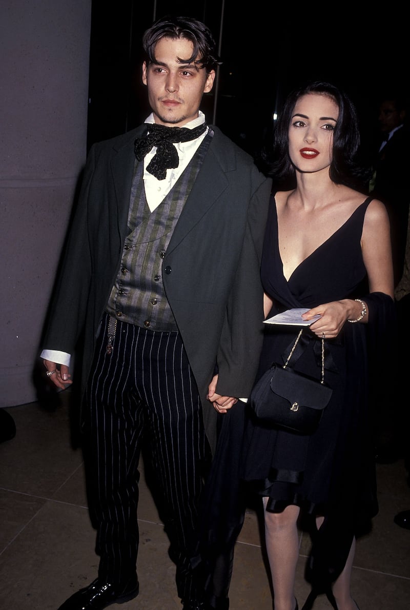 Winona Ryder, accompanied by Johnny Depp, in a little black dress at the 48th Annual Golden Globe Awards on January 19, 1991 at Beverly Hilton Hotel in Beverly Hills, California. Getty