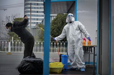 epa08242603 A worker disinfects a recovered COVID-19 patient departing a temporary hospital in Wuhan, Hubei province, China, 22 February 2020 (issued 24 February 2020). The outbreak of Covid-19 and the coronavirus, which is believed to have originated in the Chinese city of Wuhan, has so far killed at least 2,467 people and infected over 78,000 others worldwide.  EPA/SHI ZHI CHINA OUT