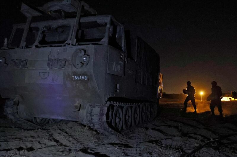 Israeli soldiers next to an ammunition carrier at their position by the border with the Gaza Strip. AFP