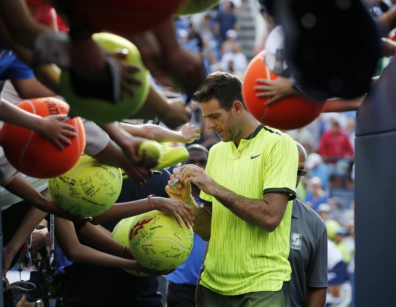Juan Martin del Potro signs autographs for fans after defeating David Ferrer  during the third round of the US Open on Saturday. Kathy Willens / AP Photo 