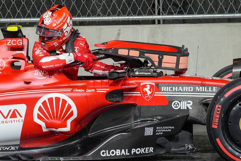Ferrari driver Carlos Sainz climbs out of his car after he stopped on track with damage during the first practice session for the Las Vegas Grand Prix on Thursday, November 16, 2023, in Las Vegas. AP
