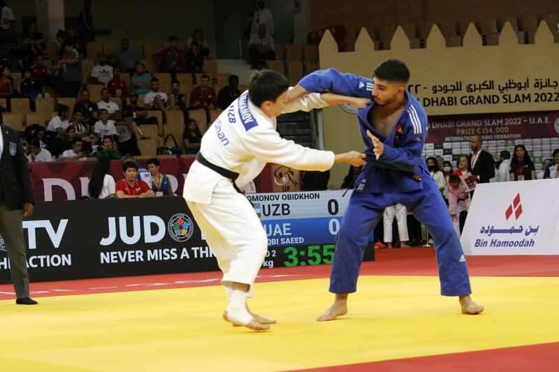 Emirati Saeed Al Naqbi, in blue, in action against Obidkhon Uzbnomonov of Uzbekistan during the Abu Dhabi Grand Prix at the Mubadala Arena on Friday, October 21, 2022. Photo: UAE Wrestling & Judo Federation