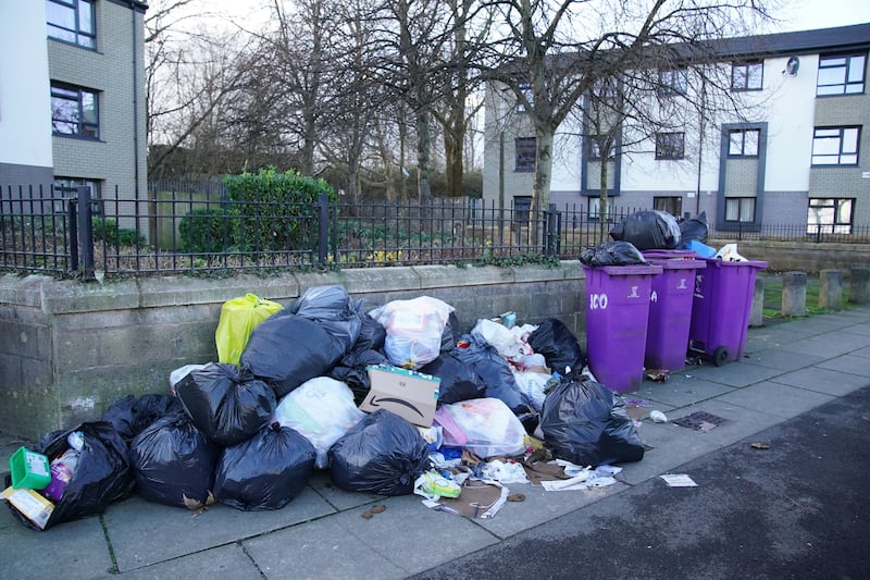 Overflowing bins in the Walton area of Liverpool, England await collection by refuse workers after coronavirus-related staff shortages.