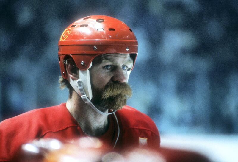 MONTREAL, QC - MAY, 1986:  Lanny McDonald #9 of the Calgary Flames stands on the bench during the 1986 Stanley Cup Finals against the Montreal Canadiens circa May, 1986 at the Montreal Forum in Montreal, Quebec, Canada.  (Photo by Bruce Bennett Studios via Getty Images Studios/Getty Images)