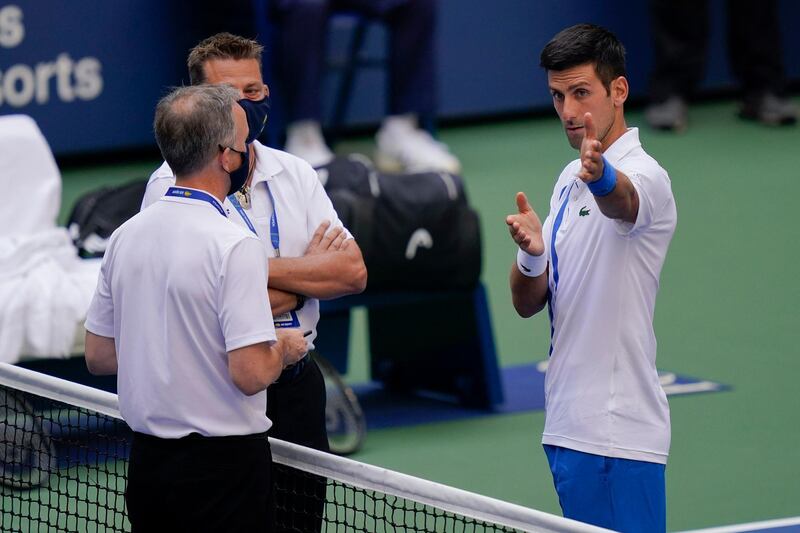 Novak Djokovic, of Serbia, talks with tournament officials after the incident. PA