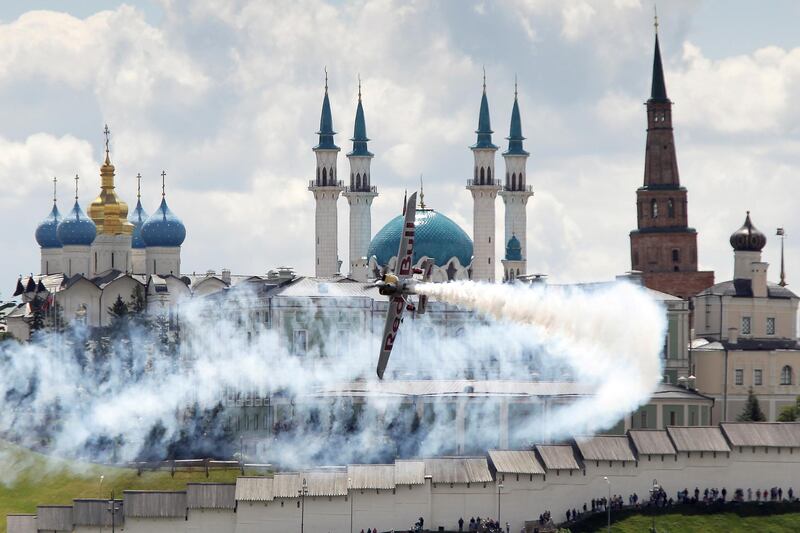 A participant operates an Edge 540 V2 plane while performing in front of the Kazan Kremlin and the Mosque of Kul Sharif, also known as Qol Sharif, during the Challenger Class free practice session of the Red Bull Air Race World Championship in Kazan, Russia. Reuters