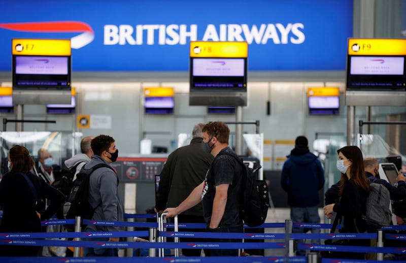 Passengers queueing at British Airways check-in desks in Heathrow Airport's Terminal 5.  Reuters