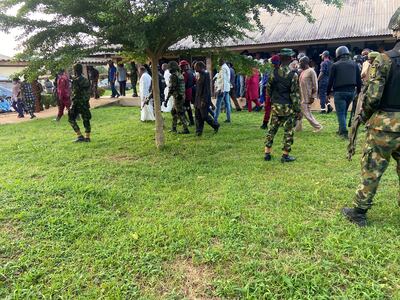 Security men guard Ondo Governor Oluwarotimi Akeredolu as he visits the victims of the attack. Reuters