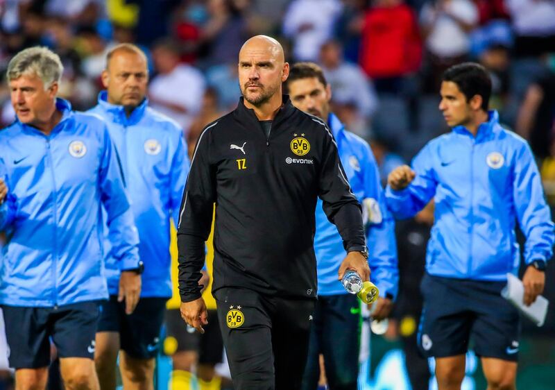 Manchester City coach Pep Guardiola leads his squad onto the field. EPA