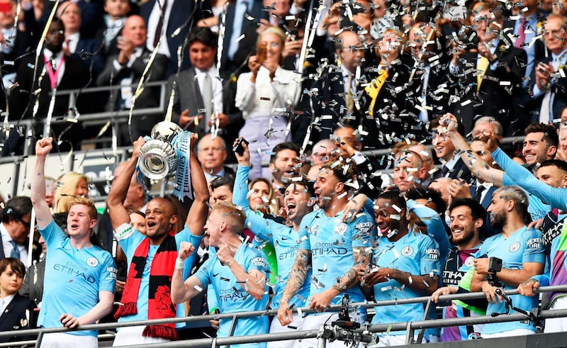 Manchester City captain Vincent Kompany lifts the FA Cup. EPA