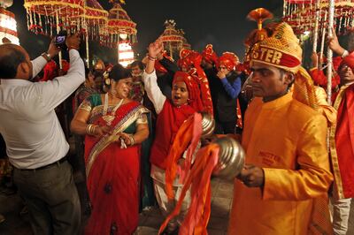 Members of a brass band play as they accompany a wedding procession in New Delhi. Jewellers are hoping that this year's wedding season will boost gold sales. AP 