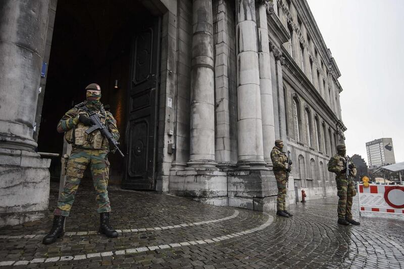 Belgian soldiers stand guard in front of the Liege Justice Palace as the city is put under highest security alert following the Paris attacks. Nicolas Lambart / AFP