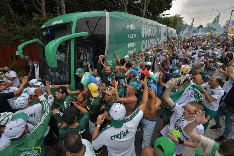 Palmeiras fans cheer as the team bus exits the training centre in Sao Paulo, Brazil. Palmeiras are on their way to Abu Dhabi to take part in the Fifa Club World Cup. AFP