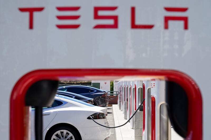 Tesla vehicles charge at a station in Emeryville, California. AP