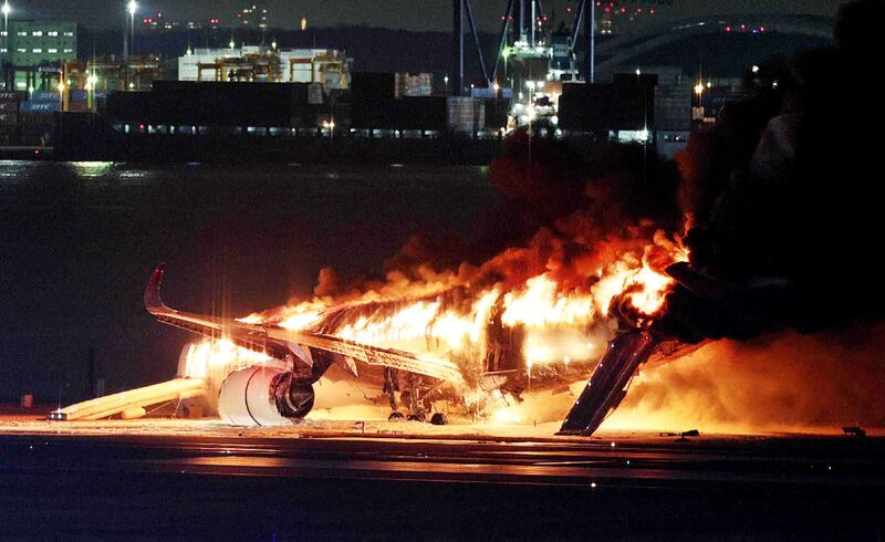 A Japan Airlines plane on fire at Tokyo's Haneda Airport. AFP