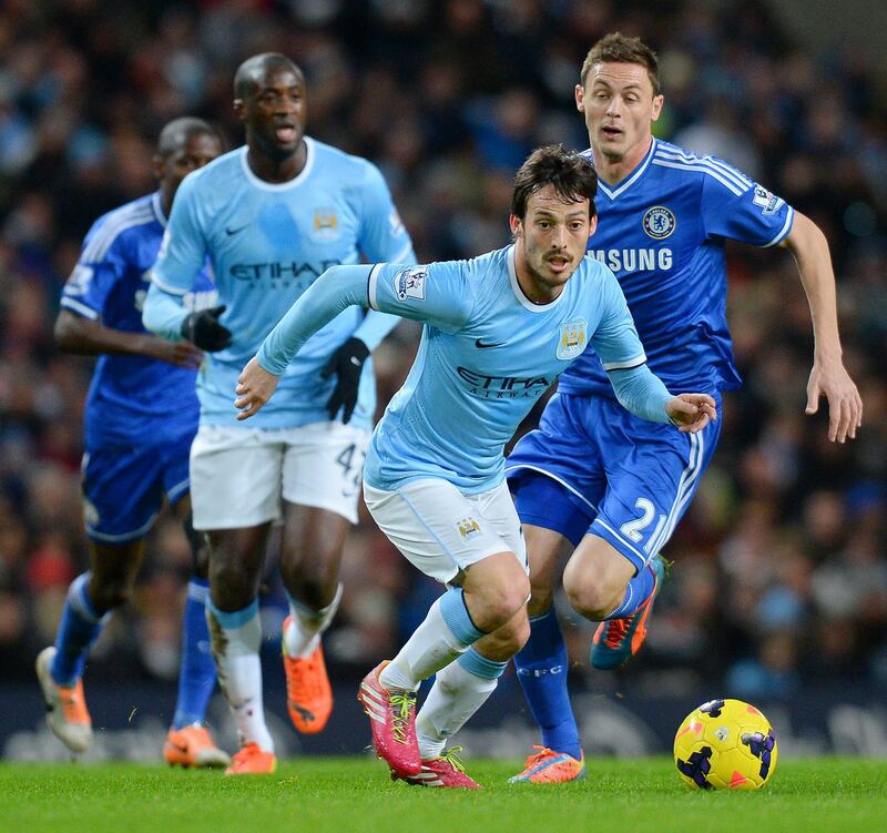 Manchester City's Spanish midfielder David Silva (Foreground) in action during the English Premier League football match between Manchester City and Chelsea at The Etihad Stadium in Manchester, north-west England, on February 3, 2014. AFP PHOTO / ANDREW YATES
RESTRICTED TO EDITORIAL USE. NO USE WITH UNAUTHORIZED AUDIO, VIDEO, DATA, FIXTURE LISTS, CLUB/LEAGUE LOGOS OR “LIVE” SERVICES. ONLINE IN-MATCH USE LIMITED TO 45 IMAGES, NO VIDEO EMULATION. NO USE IN BETTING, GAMES OR SINGLE CLUB/LEAGUE/PLAYER PUBLICATIONS (Photo by ANDREW YATES / AFP)