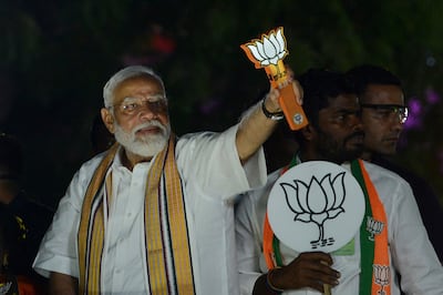 Indian Prime Minister Narendra Modi displays the Bharatiya Janata Party lotus symbol while on campaign in Chennai. AP