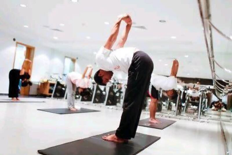 Jomon K Devassy leads an artistic yoga class at the Fit Lab at Emirates Golf Club in Dubai. Sarah Dea / The National