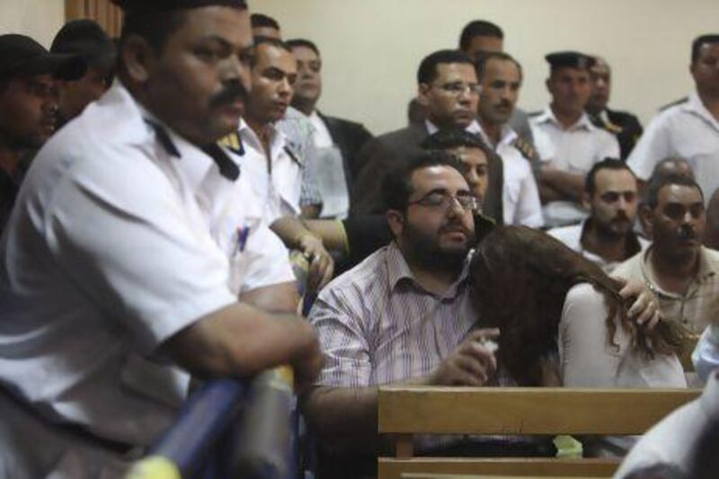 Friends of the 43 non-profit organisation workers watch on as they are found guilty of doling out funds to local NGOs without going through Egypt's ministry of international cooperation, which Egyptian law requires.
