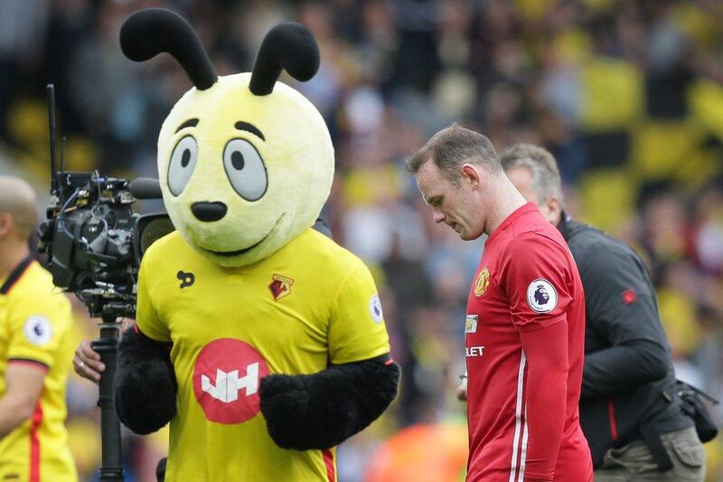 Manchester United’s Wayne Rooney walks from the pitch past the Watford team mascot ‘Harry the Hornet’ after losing on Sunday. Tim Ireland / AP Photo