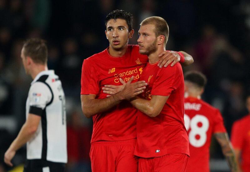 Ragnar Klavan of Liverpool and Marko Grujic of Liverpool celebrate victory in the League Cup third round match. Richard Heathcote / Getty Images