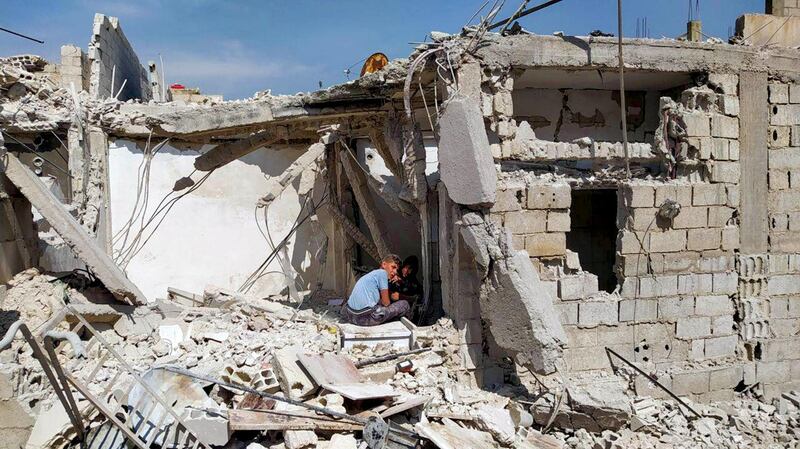 A handout picture released by the official Syrian Arab News Agency (SANA) on April 27, 2020 shows a two youth sitting amid the debris of a building after an Israeli air strike, south of the Syrian capital Damascus. - Israeli air strikes near the Syrian capital early Monday killed three civilians, state media said. "Three civilians were martyred and four others wounded, including a child, because shrapnel from Israeli missiles fell on houses" in the suburbs of Damascus, the official SANA news agency said. Syrian air defences had downed "most" of the Israeli missiles launched from Lebanese air space shortly before dawn, SANA said in an earlier report. (Photo by - / various sources / AFP) / == RESTRICTED TO EDITORIAL USE - MANDATORY CREDIT "AFP PHOTO / HO / SANA" - NO MARKETING NO ADVERTISING CAMPAIGNS - DISTRIBUTED AS A SERVICE TO CLIENTS ==