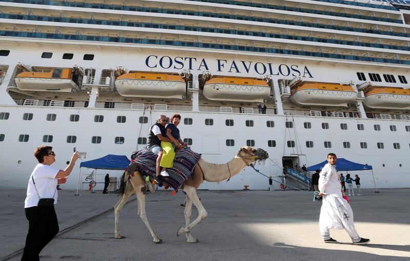 Tourists ride a camel after disembarking a Costa Cruises ship arriving from Italy, at La Goulette port in Tunis, Tunisia, 26 September 2023.  The Office of Merchant Shipping and Ports (OMMP) announced the first crossing of the Costa Cruises company, after an absence of eight years due to fears linked to the security situation in Tunisia.   EPA / MOHAMED MESSARA