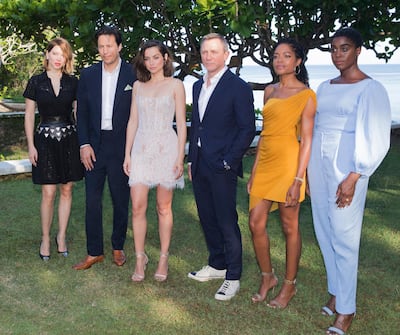 Actress Lea Seydoux, from left, director Cary Joji Fukunaga, actors Ana de Armas, Daniel Craig, Naomie Harris and Lashana Lynch pose for photographers during the photo call of the latest installment of the James Bond film franchise, currently known as 'Bond 25', in Oracabessa, Jamaica, Thursday, April 25, 2019. (AP Photo/Leo Hudson)