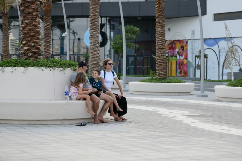 A family enjoys Yas Bay Waterfront, Abu Dhabi.
