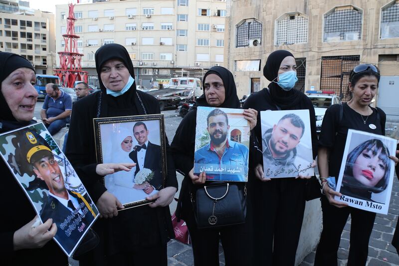 Relatives of Beirut port blast victims protest at the port entrance in support of Tarek Bitar, the judge investigating the explosion on August 4, 2020. EPA