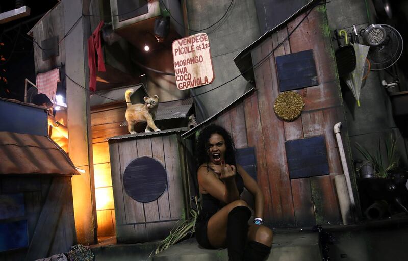 A reveller of Uniao da Ilha samba school gestures while riding a float during the first night of the Carnival parade at the Sambadrome. Reuters