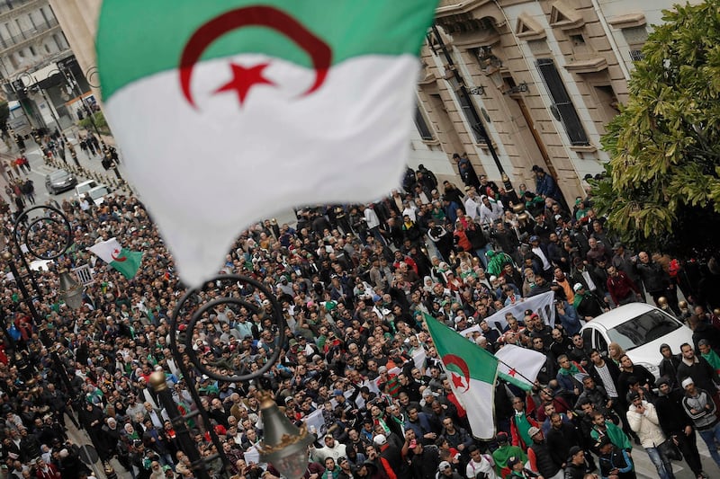 Algerians take to the streets in the capital Algiers to protest against the government and the new president Abdelmadjid Tebboune, in Algeria, Friday, Dec. 20, 2019. Algeria's governing elite hopes the new president turns the page on 10-months of peaceful but persistent protests that wants a wholesale change of power and see Tebboune as part of a discredited system. (AP Photo/Toufik Doudou)