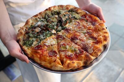 Half and half: Kale and oyster mushroom and pepperoni pizza at Marmellata. Pawan Singh / The National