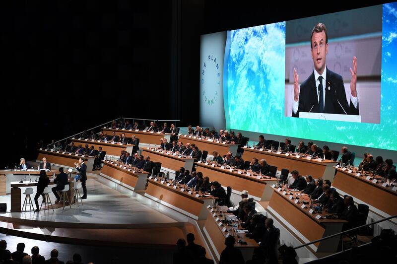 French President Emmanuel Macron is shown on a big screen as he delivers a speech at the One Planet Summit on December 12, 2017, at La Seine Musicale venue on l'ile Seguin in Boulogne-Billancourt, west of Paris.
?The French President hosts 50 world leaders for the "One Planet Summit", hoping to jump-start the transition to a greener economy two years after the historic Paris agreement to limit climate change. / AFP PHOTO / Eric FEFERBERG