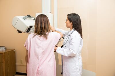 A woman is scanned for breast cancer using a mammogram. Photo: Cleveland Clinic Abu Dhabi
