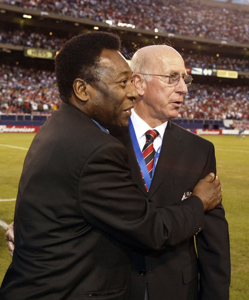 Embracing former England and Manchester United player Bobby Charlton during the friendly match between Man United and Juventus, in New Jersey, July 2003. Getty Images