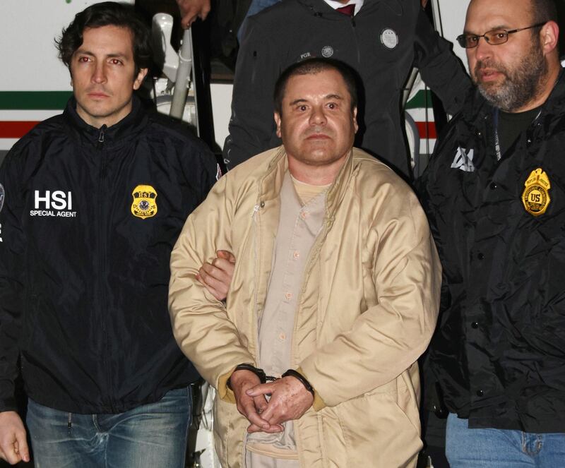 Authorities escort Joaquin "El Chapo" Guzman from a plane to a waiting caravan of SUVs at Long Island MacArthur Airport in New York State in January 2017. AP Photo