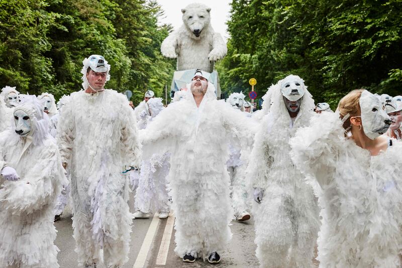 The Italian carnival troupe La Compagnia del Carnevale and members of the VIA University College Aarhus in polar bear costumes at Smukfest music festival in Skanderborg, Denmark. The procession focuses on the UN's global goals.  AFP