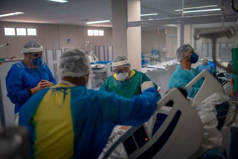 Health professionals take care of a patient at the Intensive Care Unit (ICU) ward where patients infected with the novel coronavirus, COVID-19, are being treated at the Doctor Ernesto Che Guevara Public Hospital in Marica city, state of Rio de Janeiro, Brazil.  AFP