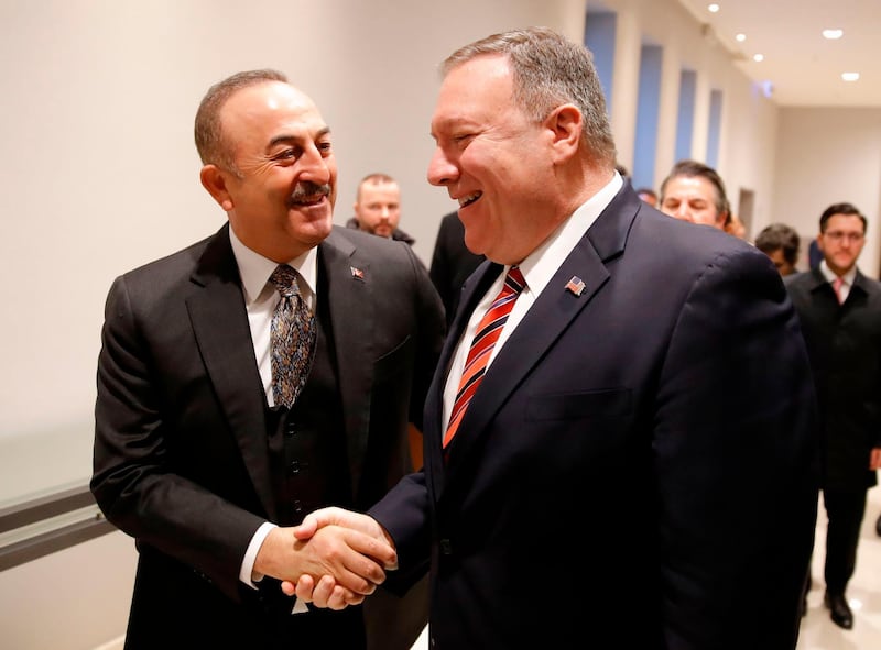 Turkish Foreign Minister Mevlut Cavusoglu shakes hands with US Secretary of State Mike Pompeo as they arrive for a bilateral meeting prior to a peace summit on Libya in Berlin. AFP