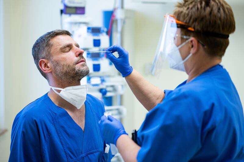 Rami Tahhan, a nursing assistant at Vivantes Clinic in Friedrichshain, Berlin, Germany, is tested for Covid-19. AP