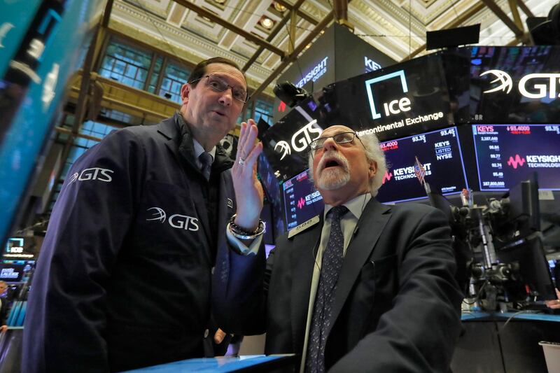 William O'Keefe, left, and Peter Tuchman work on the floor of the New York Stock Exchange, Tuesday, March 3, 2020. The Dow Jones Industrial Average dropped 785 points and bond prices surged after an emergency interest-rate cut by the Federal Reserve failed to reassure markets racked by worries that a fast-spreading virus outbreak could lead to a recession. (AP Photo/Richard Drew)