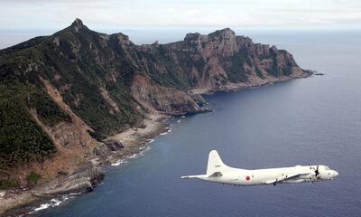 A Japanese P-3C plane is shown flying over the Senkaku Islands, the subject of a dispute between Japan and China. Jiji Press