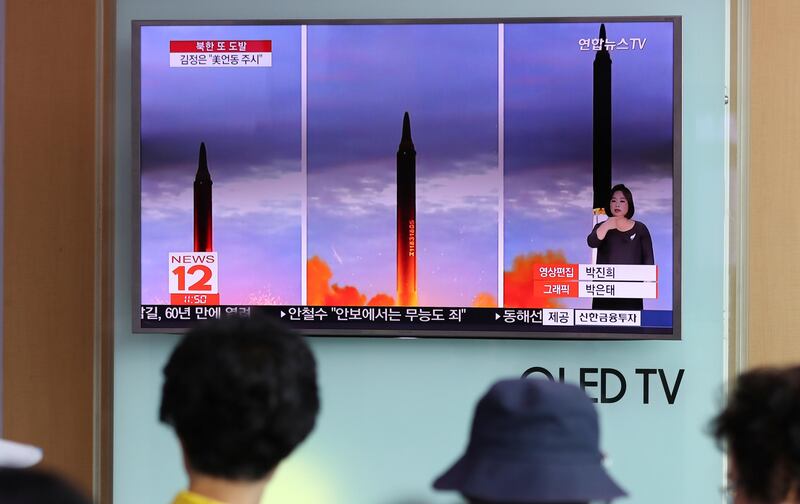 People watch a TV screen showing a local news program reporting about North Korea's missile launch at Seoul Train Station in Seoul, South Korea, Wednesday, Aug. 30, 2017. North Korean leader Kim Jong Un called for more weapons launches targeting the Pacific Ocean to advance his country's ability to contain Guam, state media said Wednesday, a day after Pyongyang for the first time flew a ballistic missile designed to carry a nuclear payload over Japan. (AP Photo/Lee Jin-man)