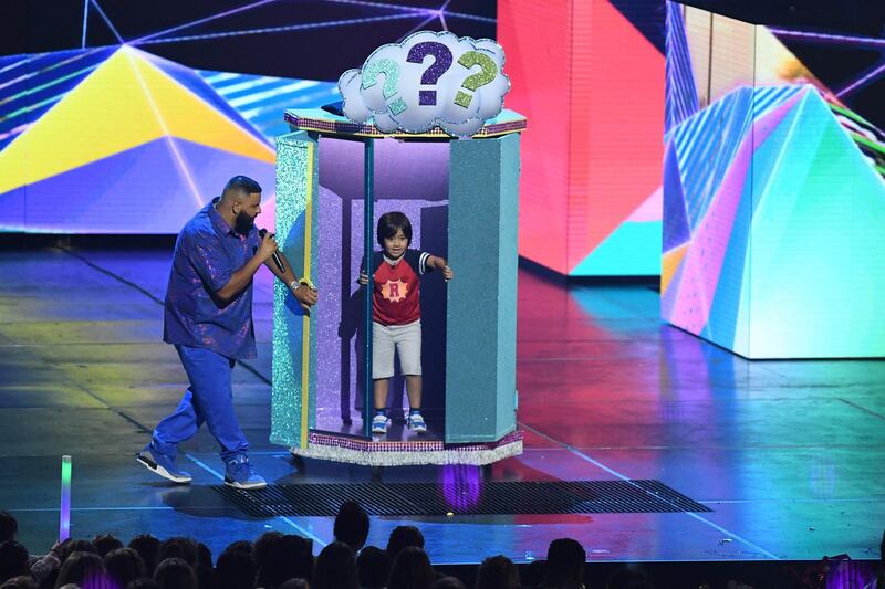 Producer/songwriter DJ Khaled, left, and Favourite Social Star nominee Ryan Toysreview appear on stage. AFP