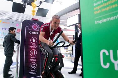 A man cycles to generate power at Dubai Internet City booth. Reem Mohammed / The National